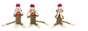 These three smiling sock monkeys embody the proverbial fundamental truth, "see no evil, hear no evil, speak no evil". These homemade animals were very popular in the US and Canada in the 1950's. Sewing instructions were provided by the company that made the socks. There have been a couple of recent revivals, however the early socks had the destinctive pointed heel, giving the frown or smile to the monkey's face.